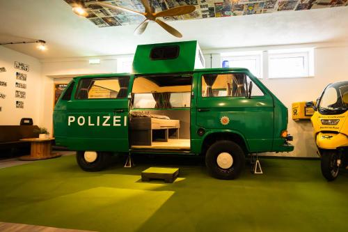 a green police van parked in a room at Oldtimer Camp Main Spessart in Collenberg