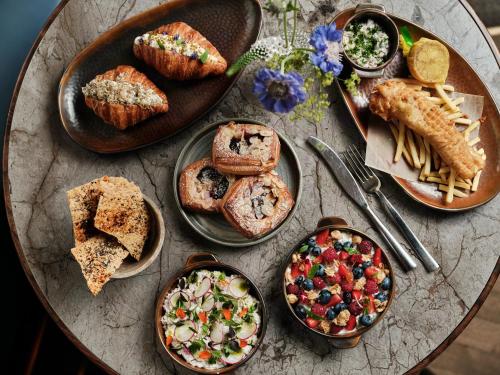 a table topped with different types of food on plates at InterContinental Warszawa by IHG in Warsaw