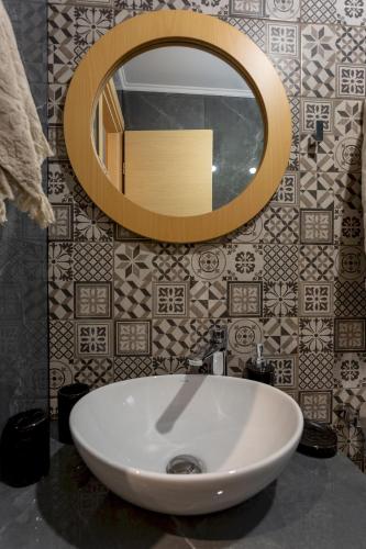 a bathroom with a white sink and a mirror at Villa Thalassa in Skaleta