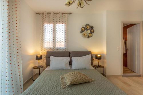 a bedroom with a bed with a pillow on it at Villa Thalassa in Skaleta