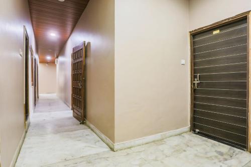 a hallway with two metal garage doors and a hallway with a corridorngthngthngth at Super Collection O Jagannath Mandir Road Formerly Paradise Residency in Rāmnagar