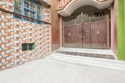 an entrance to a house with a wooden gate at Super Collection O Jagannath Mandir Road Formerly Paradise Residency in Rāmnagar