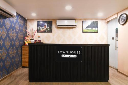 a view of a room with a tumulus sign on the wall at Super Townhouse VIP Road Formerly The Sky in Kolkata