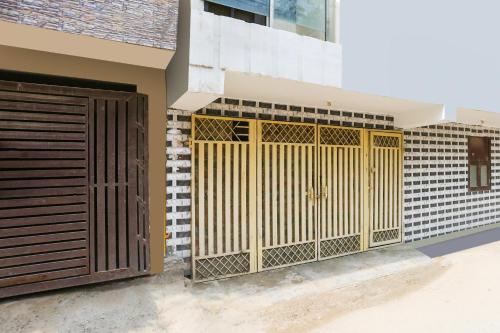 a house with a gate and a building at Super Hotel O Dwarka Metro in New Delhi