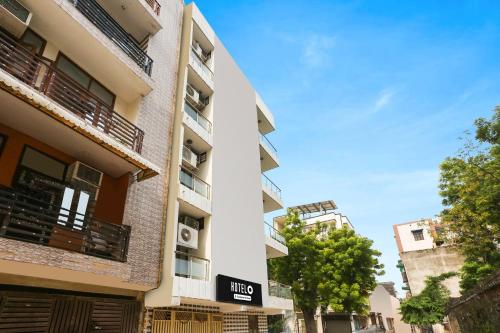 an apartment building with a sign for a hotel at Super Hotel O Dwarka Metro in New Delhi