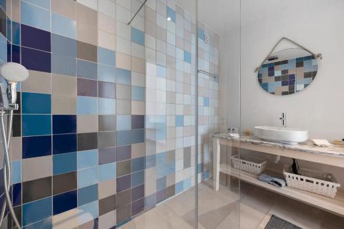 a bathroom with a sink and a mirror at Casa Surfer’s Sanctuary - Algarve in Vila do Bispo