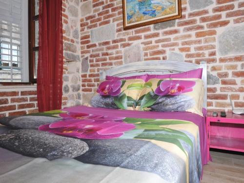a bedroom with a bed with flowers on it at Apartments Đukić in Kotor