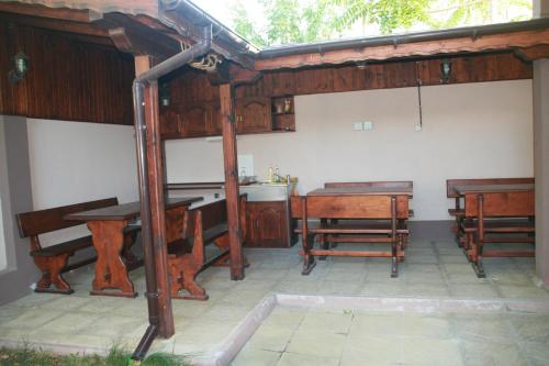 a room with wooden tables and benches and a table at Ivatea Family Hotel in Ravda