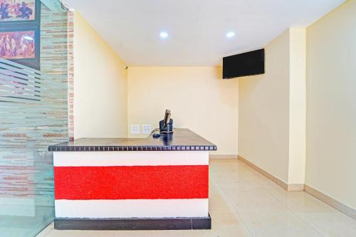 a kitchen with a counter with a sink in a room at Super Collection O Surathkal Beach in Suratakal
