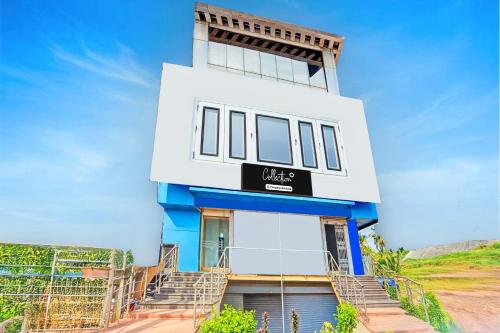 a building with stairs in front of it at Super Collection O Surathkal Beach in Suratakal
