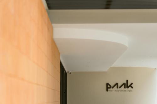 a ceiling in a room with a sign on it at PAAK Hotel Suvarnabhumi in Lat Krabang