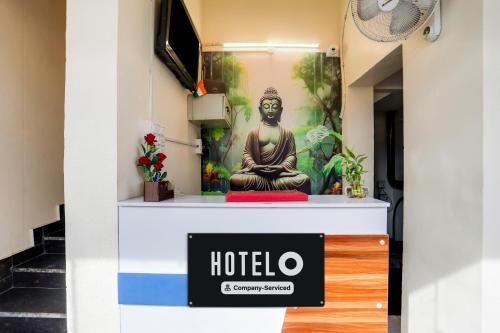 a sign for a hotel with a buddha statue at Hotel O Kota Railway Junction Formerly Formerly Aagam Inn in Kota
