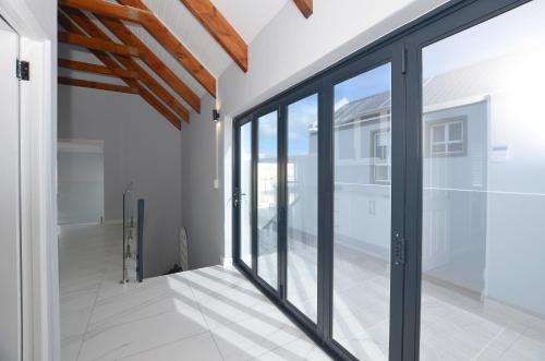 a room with sliding glass doors in a house at Ocean Breeze in Yzerfontein