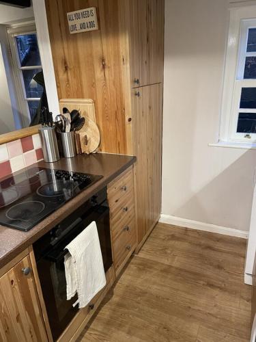 a kitchen with a stove and a counter top at Endways Cottage in Robin Hood's Bay