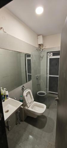 a bathroom with a toilet and a sink at Private Studio Apartment in Dhamni