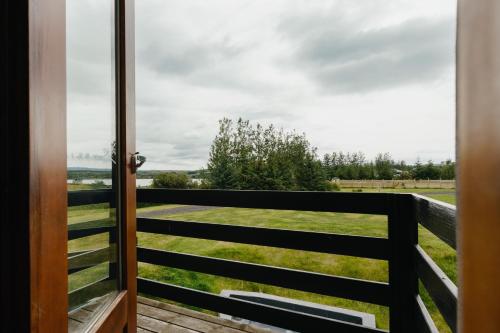 a door to a balcony with a view of a field at Hotel Kriunes in Reykjavík