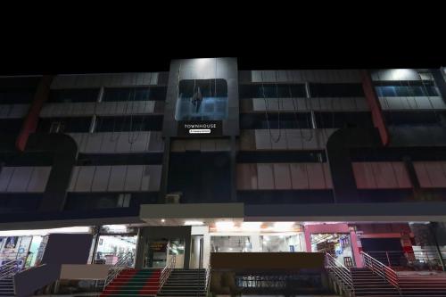 a building with a sign on the side of it at Super Townhouse Gudivada Formerly Sistla in Gudivāda