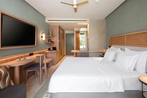 a hotel room with a large bed and a desk at SENTIDO Apollo Palace in Mesongi