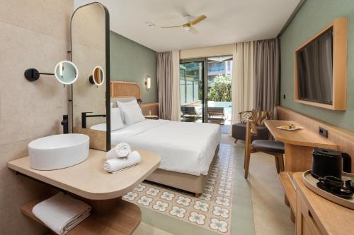 a hotel room with a bed and a bathroom at SENTIDO Apollo Palace in Mesongi