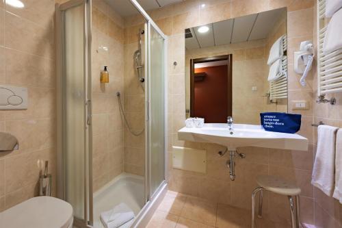 a bathroom with a shower and a sink and a toilet at La Villa - Sure Hotel Collection by Best Western in Ivrea