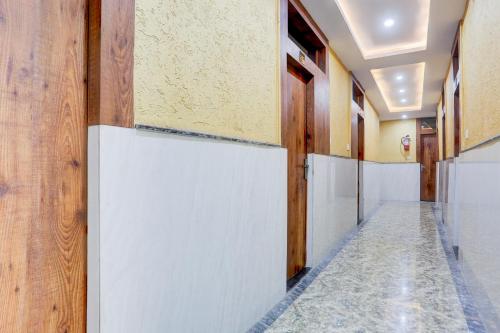 a corridor of a hallway with wooden walls and a corridorasteryasteryasteryasteryastery at Super Hotel O Mall Road Gwalior formerly Rama inn in Gwalior