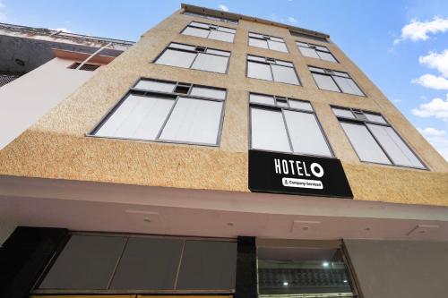 a building with a hotel sign on the side of it at Super Hotel O Mall Road Gwalior formerly Rama inn in Gwalior