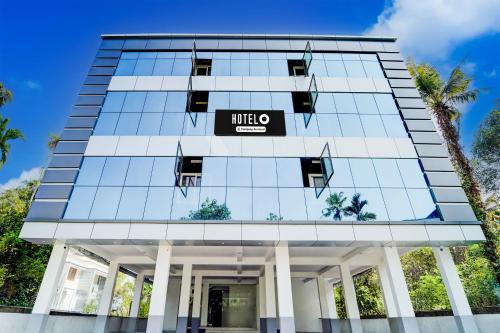a building with a mitzo sign on it at Super Hotel O North Kalamassery in Cochin