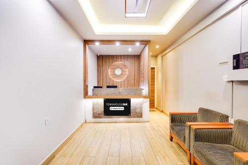 a waiting room with two couches and a fireplace at Super Townhouse Oak Kodambakkam Formerly Cine City in Chennai