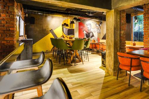 a restaurant with chairs and tables in a room at Super Townhouse Oak Kodambakkam Formerly Cine City in Chennai