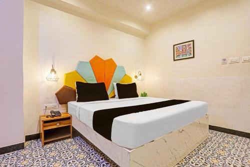 a bedroom with a large bed with an umbrella on it at Super Townhouse Cantonment Varanasi Formerly Sarin Inn in Varanasi