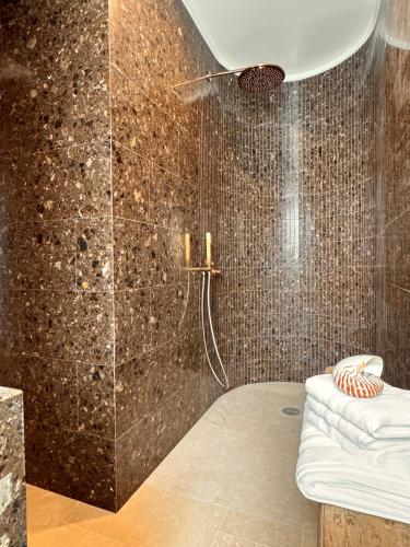 a bathroom with a shower with a shower head at Maison EMERAUDE in Rabo de Peixe