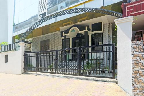 a house with an iron gate in front of a building at Super Townhouse Cantonment Varanasi Formerly Sarin Inn in Varanasi