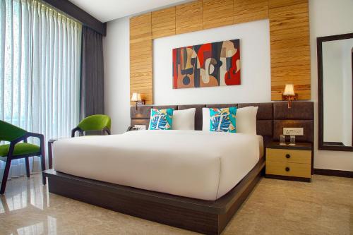 a bedroom with a large white bed in a room at TreeHouse Velis Sonipat in Sonīpat