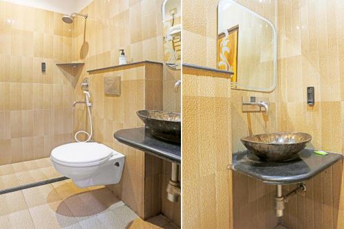 a bathroom with two sinks and a toilet at Super Townhouse Cantonment Varanasi Formerly Sarin Inn in Varanasi