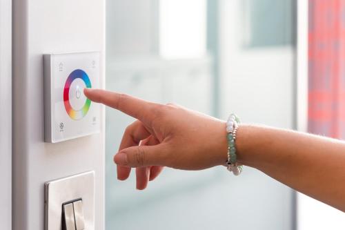 a person pointing to a button on a door at Point A London Liverpool Street in London
