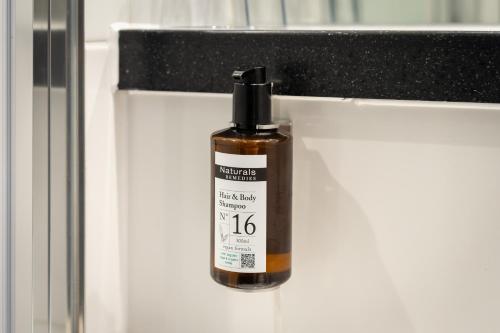 a bottle of essential oil sitting on a counter at Point A London Liverpool Street in London