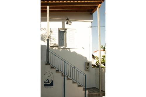 a stairway leading up to a white house at Waves Of Eros in Paralía