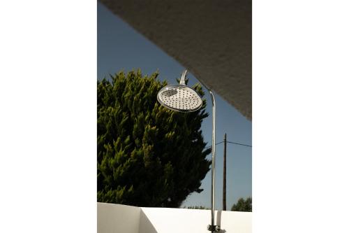 a street light in front of a tree at Waves Of Eros in Paralía