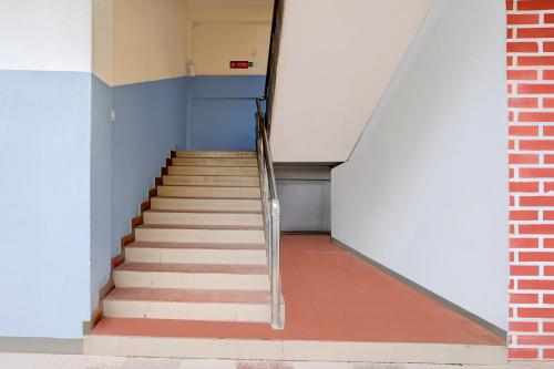 a staircase in a room with a brick wall at Super Collection O Last Gate Near Dispur Law College Formerly RR hotels in Dispur