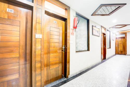 a hallway with wooden doors in a house at Super Collection O Kampoo Tiraha Road formerly Siddhi Vinayak in Lashkar