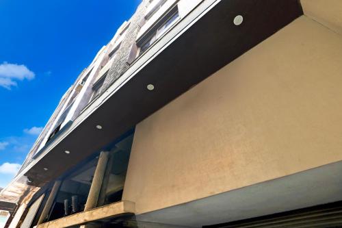 a building with windows on the side of it at Super Collection O Kampoo Tiraha Road formerly Siddhi Vinayak in Lashkar