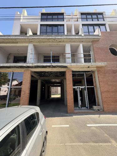 a white car parked in front of a building at Luxury Blue Apartment in Satu Mare