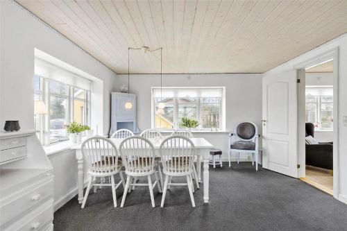 a kitchen and dining room with a table and chairs at BL1698-Blokhus-Sonder-i-by-21 in Blokhus