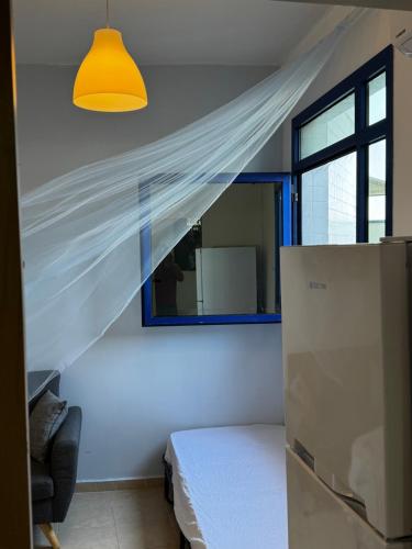 a bedroom with a bed and a window with a curtain at Swita Nir - Hot tub, Beach & Barbeque in Ashdod
