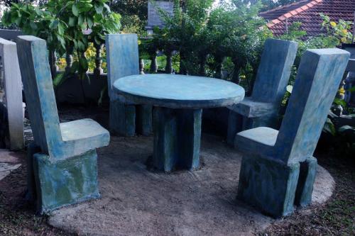 a table and two chairs with a blue table and two chairs at Blue Sky in Mirissa