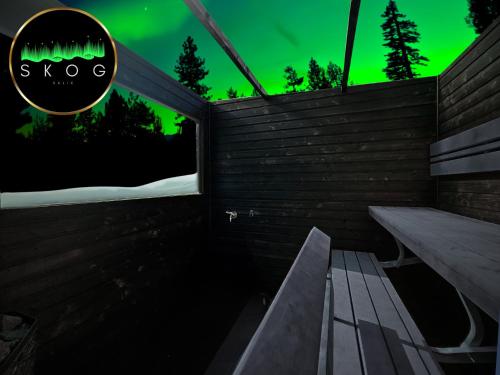 a room with a bench and a green screen at SKOG - Aurora Igloos Resort in Kalix