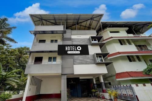 a hotel building with a sign on it at Super Hotel O Palarivattom Metro Station Formerly South Gate in Edappally