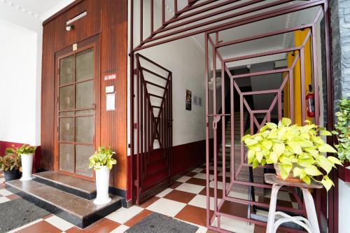 a room with a door and stairs and plants at Super Hotel O Palarivattom Metro Station Formerly South Gate in Edappally
