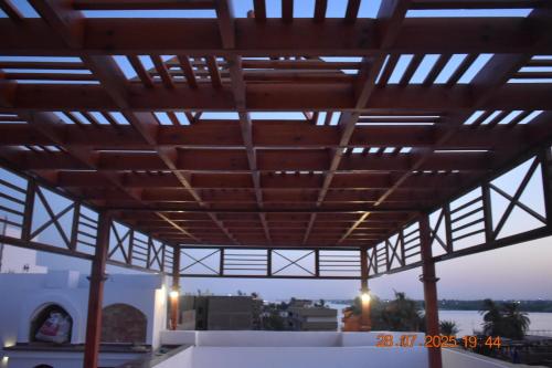 awning over a building with a view of a city at Maat apartment in Luxor