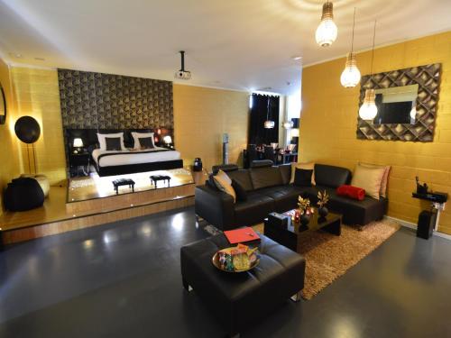 a living room with a couch and a bed at Home in Welkenraedt with Steam Shower in Welkenraedt